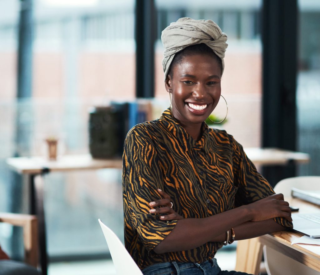Cropped portrait of an attractive young businesswoman sitting at her desk in her office with her arms folded
